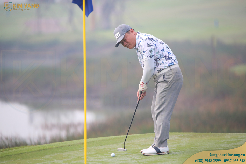 Golfer thực hiện cú đánh tee shot trong trang phục đồng phục Kim Vàng Uniform tài trợ