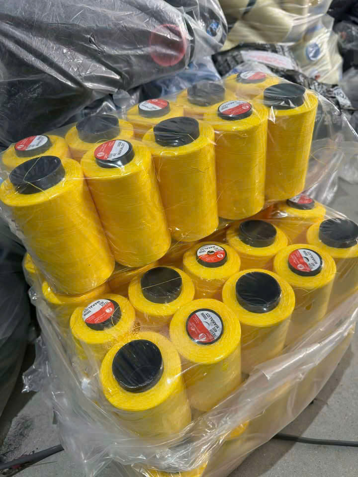 Các cuộn chỉ may màu vàng dùng trong chuẩn bị sản xuất đồng phục SSIT.